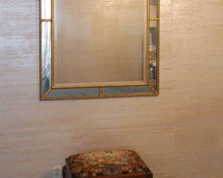 A double rectangle mirror with a border of tilted beveled mirrors, hand applied antique gold leaf finish