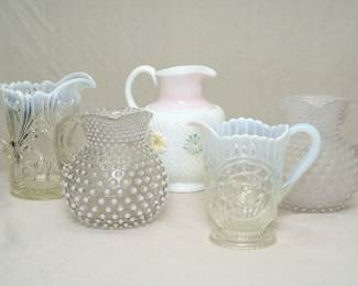 5 pressed glass pitchers, late 19th century/early 20th century, including ones from Jefferson Glass Company, a Dugan pressed glass Circled Scroll pitcher/creamer, a Consolidated Glass milk glass Cosmo patter pitcher or jug, and two EAPG hobnail pitchers