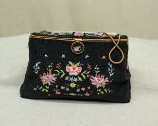 Charming little work of art! A vintage (1930s-1940s?) hand made in France black beaded and Point De Beauvais embroidery handbag. Black seed glass beads, embroidered flowers, gold tone metal frame, clasp and chain handle; interior lined with cream color fabric and an inside pocket contains original added coin purse! Marked inside as Saks Fifth Avenue Made in France.