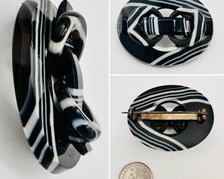 Antique Scottish brooch of black and white banded agate carved in an oval buckle form. Sterling and steel pin on the back; unmarked