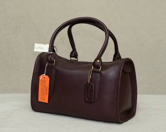 Incredible find – a NWT new with tag Coach brand handbag, purchased at Marshall Field's. Deep coffee brown color, possibly the Madison Satchel model; interior stamped with No. 150-8615.