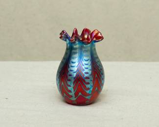 Charles Lotton art glass vase, zipper design of pulled blue green over red ground, crimped rim; engraved signature to base.
