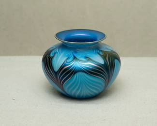 A graceful American art glass vase by Charles Lotton (1935-2021), compressed globular form with flared rim, pulled feather design in various shades of blue; wonderful iridescence. Signed and dated 1989.