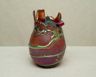 A Charles Lotton Cypriot Lava art glass vase. Signed and dated "1991". Iridescent gather over dark red orange textured ground. Pinched rim.