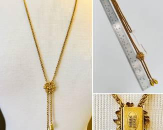 A vintage signed Miriam Haskell gold tone lariat / slide chain necklace, the slide a dimensional floral spray and the chains ending with a tear-shaped textured bead