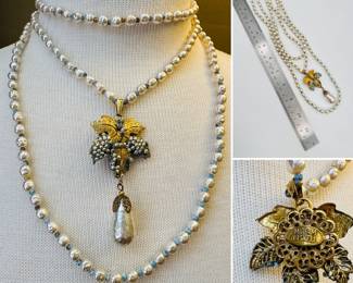 A fabulous vintage Miriam Haskell necklace comprised of three different length strands of glass baroque pearl style beads spaced with blue beads, the middle strand with a grape leaves and grapes pendant that suspends one large glass baroque pearl bead. Needs some restoration.