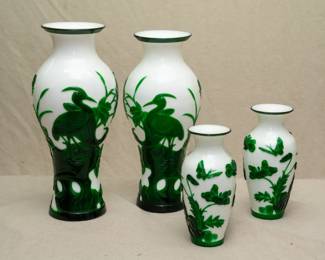 Pair of Chinese Peking Glass vases, carved green overlay on white ground, decorated with stylized cranes on Taihu rocks amidst water plants, and a smaller pair of Chinese Peking Glass vases, carved green overlay on white, decorated with butterflies and flowering plants