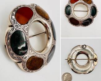 Antique Scottish brooch or kilt pin, sterling silver lobed circular form with bloodstone, red jasper, and agate stones, the silver ornately engraved. Unmarked silver, with a jump ring at the back so it can also be worn as a pendant.