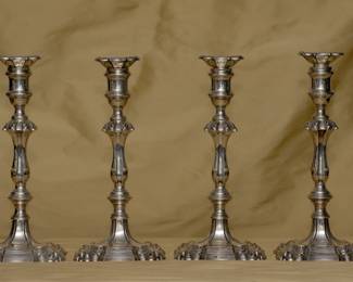 A matched set of four antique English sterling silver candlestick holders, stamped with hallmarks for sterling silver, London, and silversmith Lionel Alfred Crichton. Crichton & Co. was established around 1890 by Lionel Alfred Crichton. In 1920 the firm was active with premises in London (22 Old Bond Street), New York (636 Fifth Avenue) and Chicago (622 South Michigan Avenue). The British Museum has Crichton pieces in its permanent collection.