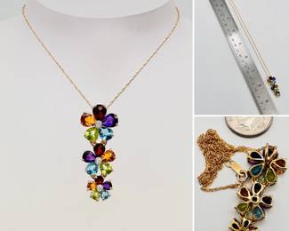 14k yellow gold pendant necklace on delicate chain - the pendant of three flower shapes in descending size set with diamonds, the petals are garnet, topaz, amethyst, peridot, and citrine