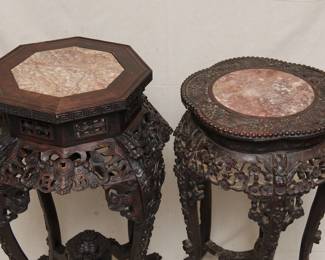 A closer look at the pair of Chinese hand carved marble topped occasional tables or stands, one with octagonal top and motif of bats and coin symbols, the other with a lobed top and plum blossom and dragons motif