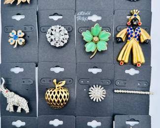 Costume jewelry brooches including a sweet Crown Trifari molded green glass dogwood brooch