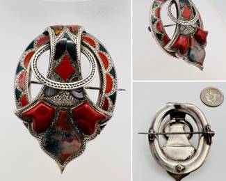 A marvelous antique Scottish sterling silver brooch or kilt pin, mid-19th century; exquisitely hand crafted Scottish pebble jewelry in a buckle form, set with bloodstone, jasper and agate, with Celtic engraved detail throughout.