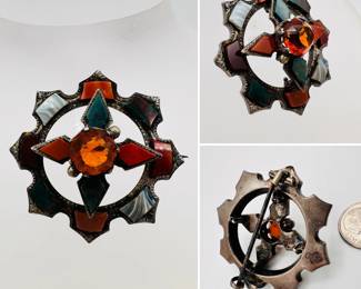 Mid-19th century sterling silver Scottish brooch or kilt pin, round outer ring with rectangles of agate, red jasper, carnelian, bloodstone; with a raised cruciform frame displaying bloodstone and red carnelian around a round faceted deep orange quartz stone. Provincial town / maker's stamp on the back.