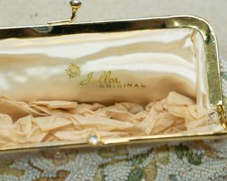 Closeup of Jolles Original vintage hand beaded clutch purse evening bag, metal frame with rhinestones in clasp