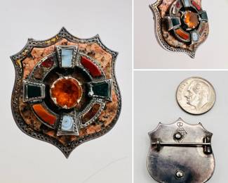Antique 19th century Scottish sterling silver brooch in shield shape, the shield and raised central silver ring decorated with agate, jasper, bloodstone, and carnelian around a claw set faceted citrine stone. Provincial town stamp on the back.