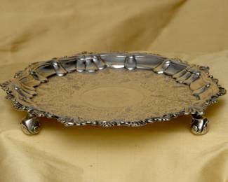 18th century sterling silver salver, center decorated with a coat of arms inside a wide band of floral and water plants with swimming ducks; English hallmarks