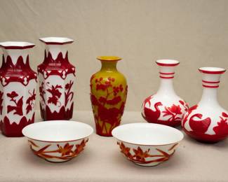 A beautiful pair of Peking Glass / Beijing Glass six-sided vases, decorated in cameo glass style with carved deep red overlay on white ground; a Peking Glass vase in opaque yellow glass with carved overlay of red depicting flowering plants; a pair of of Chinese Peking glass bowls with carved red overlay of flowers, and a pair of Chinese Peking Glass or Beijing Glass vases with carved brilliant red overlay showing ducks swimming amidst flowering lotus, two "string" bands in red glass on the neck and red band on the rim.