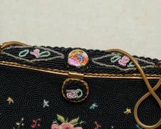Closeup of vintage hand made in France black beaded and Point De Beauvais embroidery handbag, made in France, sold by Saks Fifth Avenue.