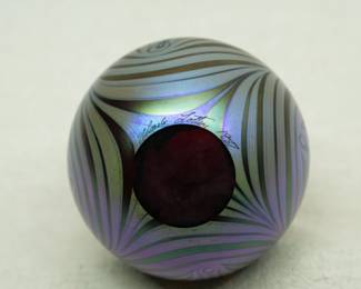 Closeup of a Charles Lotton art glass vase, pulled feather design in rich iridescent colors; signed and dated 1987.