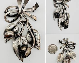 A sterling silver brooch, ribbon with pendant floral sprig; signed on the back John L. B305 Denmark