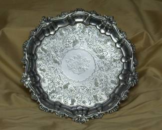 Another view of the 18th century sterling silver salver, center decorated with a coat of arms inside a wide band of floral and water plants with swimming ducks; English hallmarks