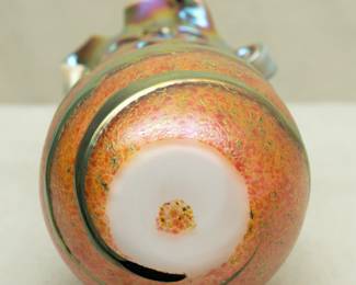 Closeup of a Charles Lotton Lava Cypriot art glass vase. Signed and dated 1992. Cased glass, iridescent greenish gold gather over an orange textured ground. Pinched rim.