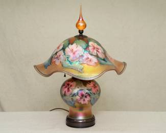An exquisite hand made art glass lamp by American art glass master Charles Lotton (1935-2021), Illinois. This lamp shows Lotton's "Multi Flora" design, iridescent gold ground with beautiful flower blossoms and leaves, and with original finial.