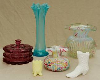 EAPG cranberry/ruby glass lidded candy jar, a Fenton Art Glass Boggy Bayou blue opalescent swung vase, a Peloton art glass ribbed clear with colored threads glass vase, the rim curled in a distinctive tricornered shape; a Bob St Clair Fan & Feathers custard glass footed toothpick holder, a smaller Peloton Art Glass ribbed vase, opaque white with the colored Peloton threads, the rim curled in a distinctive tricornered shape; and a vintage Fenton milk glass Button & Daisy boot.