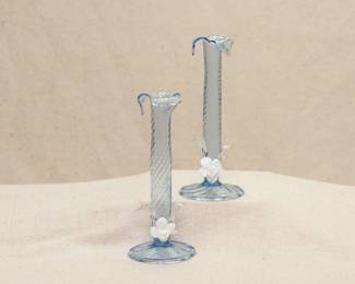 A pair of pale blue art glass candlestick holders, hand blown diamond quilted with pulled flared rims, applied clear glass leaves and opaque white blossoms above the circular base