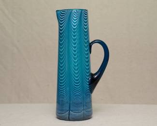 A stunning art glass Nailsea style pitcher, blown glass in bright blue with white pulled into vertical ribs in a "drapery" or feathers design; applied dark blue handle; possibly Mt Washington glass.