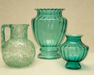 A clear glass pitcher with aqua green Peleton threads, a vintage Anchor Hocking teal blue/green ribbed art deco glass vase, and a smaller Anchor Hocking vase from the same line.