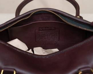 Closeup of the NWT new with tag Coach brand handbag, purchased at Marshall Field's. Deep coffee brown color, possibly the Madison Satchel model; interior stamped with No. 150-8615.
