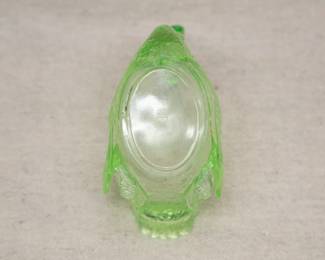 A view of underside of one of the two small swan cups from the vintage Cambridge vaseline glass or green uranium glass swan punch bowl, with two small matching swan shape cups. The cups marked to the base with the letter "C" in a triangle; the set dates to the 1930s.