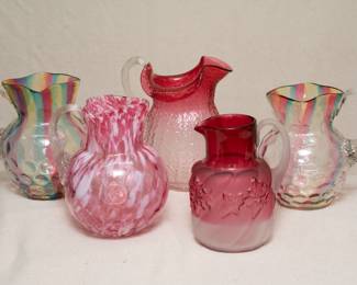 A pair of rare "rainbow" colored glass thumbprint or coin dot pattern art glass pitchers, a Fenton Murrhina Rose Mist thumbprint glass pitcher or jug, a cranberry to clear textured glass pitcher, and a Northwood frosted Rubina cranberry glass swirl Royal Ivy pattern pitcher