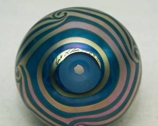 Closeup of a Charles Lotton iridescent art glass vase, 'King Tut' pattern/design in blues, greens, and gold. Signed and dated 1988.