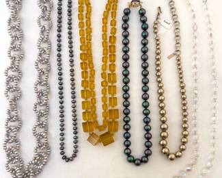 A variety of vintage beaded necklaces, some with sterling silver clasps