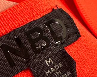 Closeup of NBD red knit sleeveless dress, size M