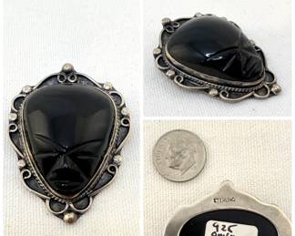 Sterling silver and carved onyx face brooch