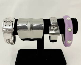 A vintage Ralph Lauren silver buckle bracelet, a wide silver cuff bracelet, another fabulous silver buckle bracelet and a lilac and faux pearl studded bangle bracelet