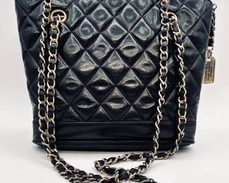 Vintage Chanel lambskin Matelassé shoulder bag, navy with plate charm and chain handle; authenticated with Entrupy