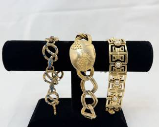 A brilliant enameled winding serpents bracelet, a modernist textured metal link bracelet, and an art deco revival link and pearl bracelet