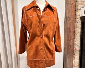 Vintage 1970s Oscar de la Renta cognac suede coat, lined, with leather blanket stitching throughout, button closure. Made in Spain, likely a size Medium.