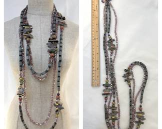 Long beaded necklaces with carved animals, natural stone, and faceted crystal beads