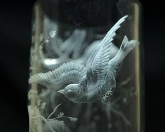 Closeup of the incredible 15-inch tall art glass vase shading from clear to cranberry, beautifully wheel cut or engraved with detailed scene of birds in flight amidst flowering branches and vines. Possibly Moser Glass.