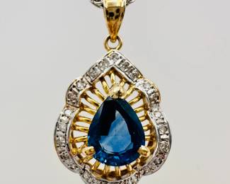 Closeup of 14k yellow and white gold sapphire and diamonds pendant necklace