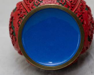 Closeup view of the two vintage Chinese large cinnabar lacquer vases, beautifully carved with floral motif and scrolling design on a black geometric ground, original maker's label to underside of one of the vases.