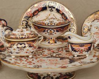 Closeup of the group of 18th and 19th century Crown Derby Imari 'Kings' pattern porcelain, including tea cups and coffee cups with saucers, teapot, coffee cups, footed large serving platter/lazy susan, lidded sauceboat with tray, creamer, sugar, serving bowls and platters, and a footed compote or fruit stand