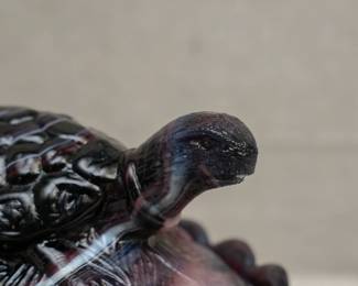 Closeup of the vintage purple slag glass turtle covered dish, pressed glass