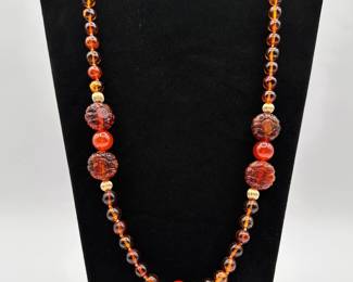 Another view of the 14k yellow gold and Chinese carved amber and carnelian color beaded necklace, glowing rich honey color amber beads, Chinese characters carved in the large amber beads 